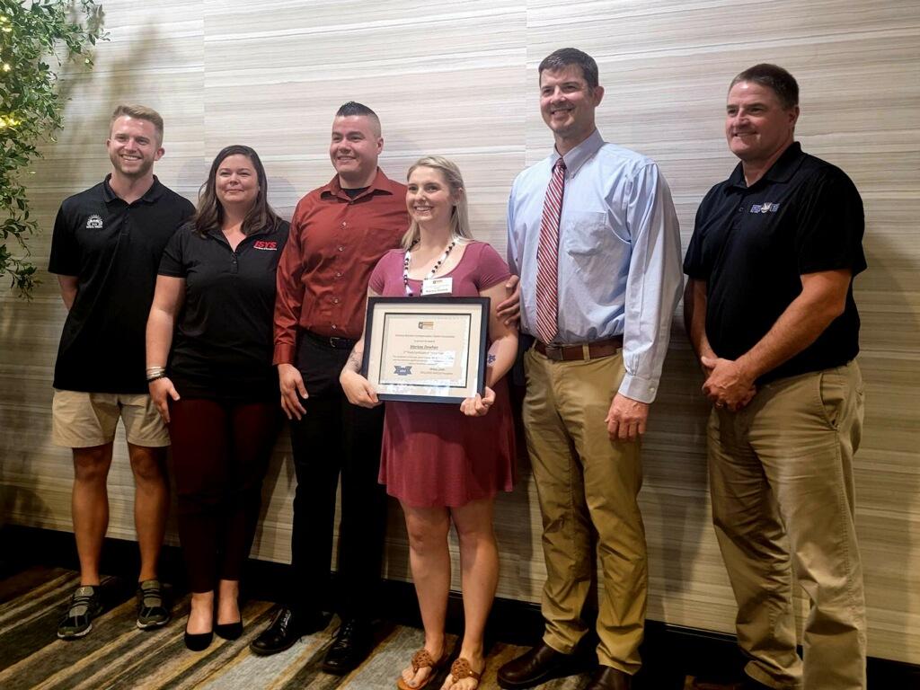 Officer Marissa Dowhan receiving the ROTY (Rehabilitant Of The Year Award) with ISYS Nurse Case Manager, Ashley R., RN, and the rest of the care team.